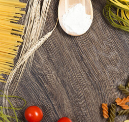 Wall Mural - pasta, tomatoes and flour on the spoon