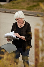 Senior Woman Standing Near Mailbox