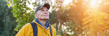 Old Happy Male Hiker With Backpack Looking On Mountain Top Forest Background