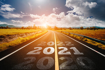 Wall Mural - The word 2020-2022 written on highway road in the middle of empty asphalt road at golden sunset and beautiful blue sky. Concept for new year 2020-2022.