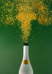 Wall Mural - Champagne bottle explosion with golden glitter on green background. Flat lay. Minimal party concept. New Year and Christmas celebration idea.