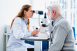 © InsideCreativeHouse - Female ophthalmologist examining mature man`s eyes