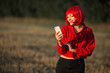 portrait of beautiful young female with red hair with mobile phone
