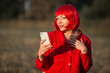 portrait of beautiful young female with red hair with mobile phone
