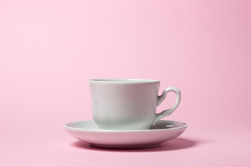 Coffee cup on a pink background. Coffee cup and saucer.