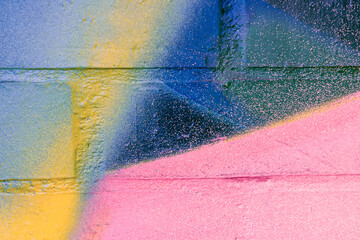 Art under ground. Beautiful street art graffiti background. The brick wall is decorated with abstract drawings house paint. Modern style urban culture of street youth. Abstract picture on wall