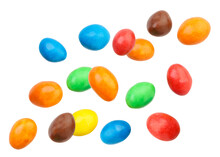 Candy peanuts covered with chocolate in a multicolored glaze fly on a white background. Isolated