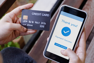 Online shopping, mobile payment. Woman hands holding credit card and using smart phone for online payment