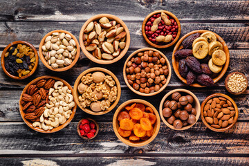 Wall Mural - Various Nuts and dried fruits in wooden bowls.