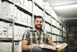 © Antonio Recena - Man works in archive and reviews the different files