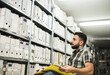 © Antonio Recena - Man works in archive and reviews the different files
