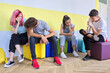 © Valerii Honcharuk - Group of teenage students at school sitting resting talking
