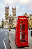 Fototapeta Londyn - London, UK - 04 2015: An iconic red phone boot near Westminster Abbey