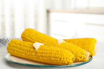 Canvas Print - Fresh corn cobs with butter on white wooden table