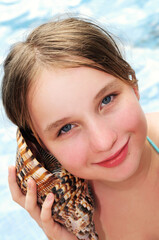 Wall Mural - Young girl with seashell