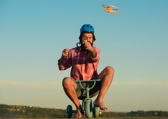 Wall Mural - Childhood memory. Funny man riding a small bicycle.