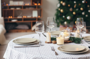 Beautiful table setting with Christmas decorations in living room