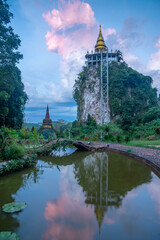 Wall Mural - View of the temple gate and golden pagoda at Thailand.