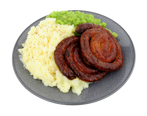 Wall Mural - Cumberland pork sausage swirl and mashed potato meal with mushy peas isolated on a white background