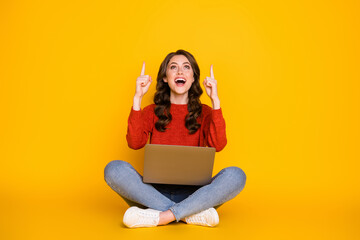 Canvas Print - Photo of attractive funny lady sit floor legs crossed work computer remote worker education home direct fingers up empty space wear casual outfit isolated yellow color background