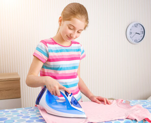 Beautiful girl doing ironing in light room