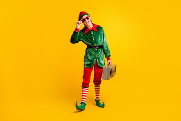 Poster - Full length body size view of his he nice attractive skinny glad cheerful cheery funny guy elf carrying player having fun isolated over bright vivid shine vibrant yellow color background