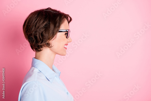 Close-up profile side view portrait of her she nice attractive lovely content cheerful cheery glad brown-haired girl executive assistant agent broker copy space isolated pink pastel color background