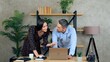 © viacheslav - Smiling man and woman employees working together in an office preparing presentation for meeting. Manager shows report to businesswoman on laptop computer