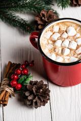 Canvas Print - Cup of cocoa with marshmallows near cinnamon sticks with red beads and pine cone