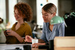 © JustLife - Businesswomen working on a new project. Colleagues discussing work in office