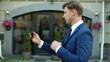 © stockbusters - Focused business man having video conference online by smartphone outdoors