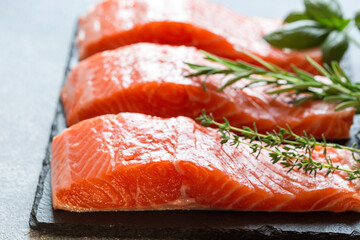 Wall Mural - Salmon. Fresh raw salmon fish fillet with cooking ingredients, herbs and lemon. Close up. healthy food, diet or cooking concept