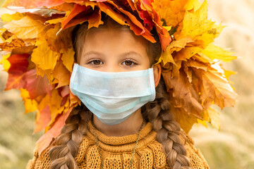 Wall Mural - A little girl with a medical mask on her face.
