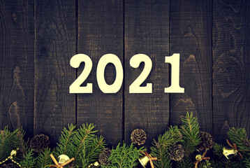 Wall Mural - Top view of a decorated Christmas tree and number 2021 as a symbol of the coming New Year. Happy New Year Holiday concept on a rustic wooden background. Christmas greeting card. Flat lay