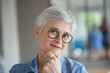 © goodluz - portrait of a beautiful smiling 55 year old woman with white hair
