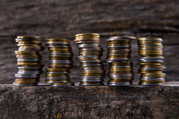 collection of colorful metal coins on wooden background, close view 