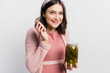 © LIGHTFIELD STUDIOS - joyful and pregnant woman holding jar with pickled cucumbers isolated on white