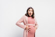© LIGHTFIELD STUDIOS - shocked and pregnant woman looking at camera and touching belly on white