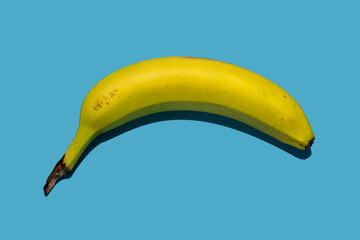 Natural sweet ripe yellow banana isolated on blue