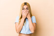 © Asier - Young blonde caucasian woman shocked covering mouth with hands.
