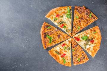 Wall Mural - Various italian american traditional pizza slices. Slices of delicious pizza on dark grey concrete background, top view flatlay