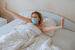 Woman wake up with surgical mask, coronavirus protection