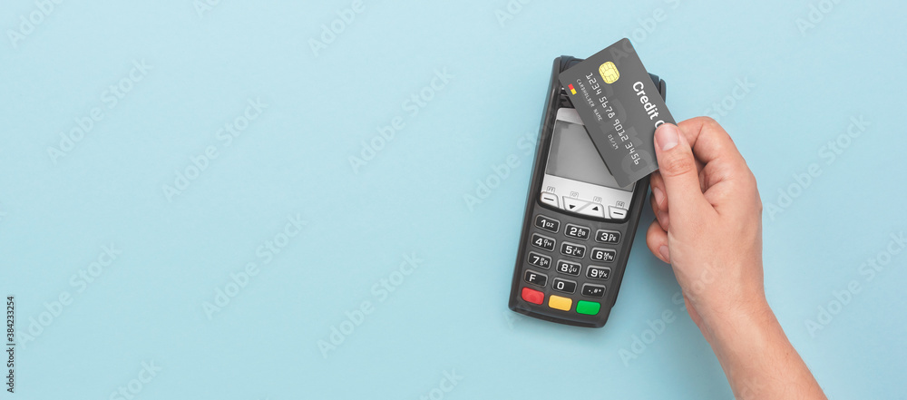 Man using credit card and payment terminal - obrazy, fototapety, plakaty 