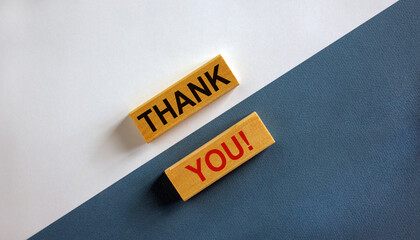 Concept words 'thank you' on wooden blocks on a beautiful white and blue background. Business concept. Copy space.