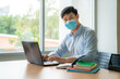 © ake1150 - Asian university student boy wearing face protective medical mask for protection from virus disease working with laptop at college. Education, high school, university, learning and people concept