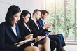 © khwanchai - multiracial job candidates people sit in queue line feel anxious wait for interview, stressed multiethnic applicants get ready for work recruitment talk, employment concept
