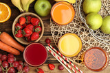 Fototapeta Kuchnia - Glasses of delicious juices and fresh fruits on wooden table, flat lay