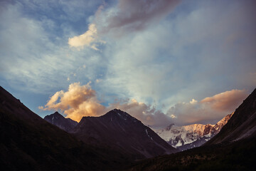 Wall Mural - amazing vivid landscape of sunset with awesome mountain silhouettes and orange clouds. atmospheric h