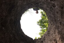 Man Looks Into A Huge Pit. View From The Bottom Of Pit. 