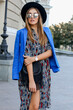 © Svetlana Sokolova - Fashionable  girl in elegant  autumn outfit walking while holidays in Europe. Stylish leather bag.  Blue jacket and black hat.